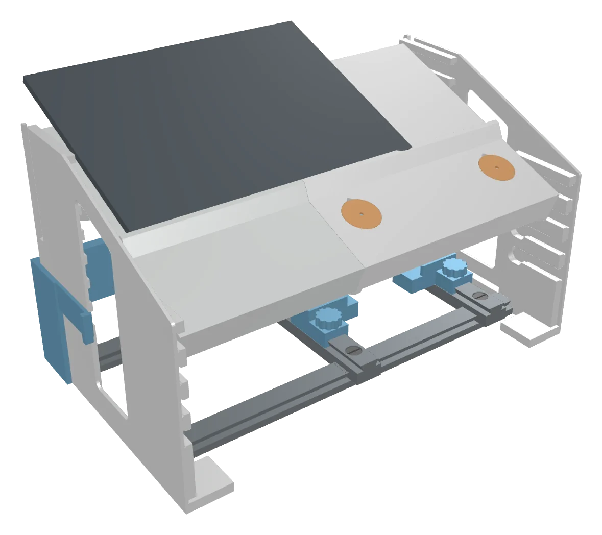 The LapLab trainer: two side stands holding an angled port plate with two instrument ports, a phone lying on the plate, and a sliding module rack underneath.